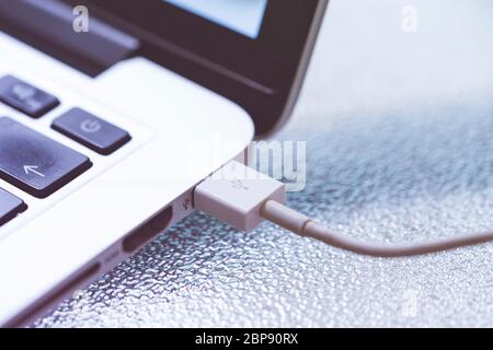 usb cable into laptop, close up photo Stock Photo