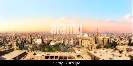 Sights of Cairo panorama: the Mosque-Madrassa of Sultan Hassan, the city view and the Pyramids. Stock Photo