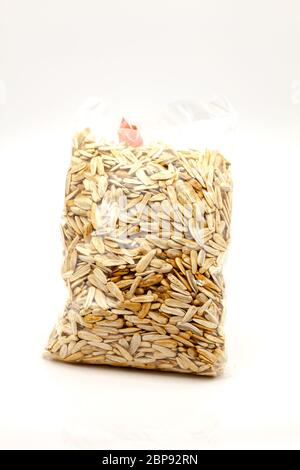Seeds of large white roasted sunflower, packed in a transparent plastic bag. Selective focus with shallow depth of field. Stock Photo