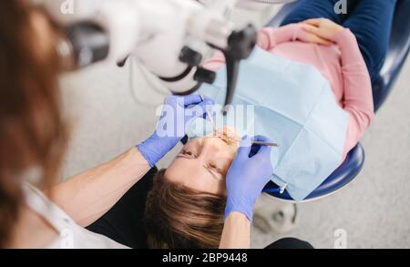 Top view of woman having dental check-up in dentist surgery. Stock Photo