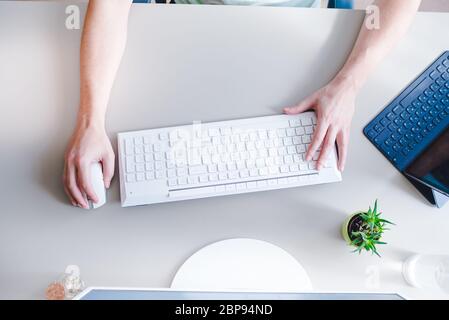 the developer works at computer, uses the mouse Stock Photo