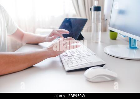 the developer works at computer, uses the mouse Stock Photo