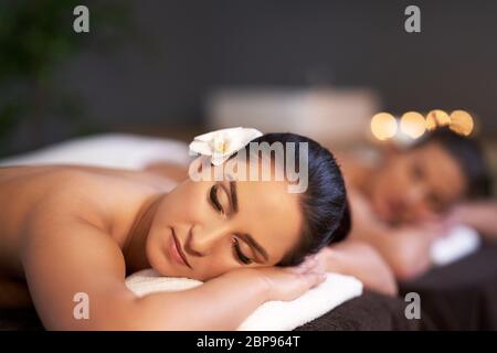 Relaxed girl friends receiving back massage Stock Photo