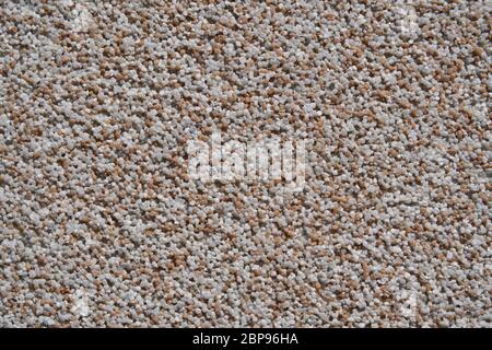 close view of the wall surface, decorative finishing, heat insulation granules or granite particles Stock Photo