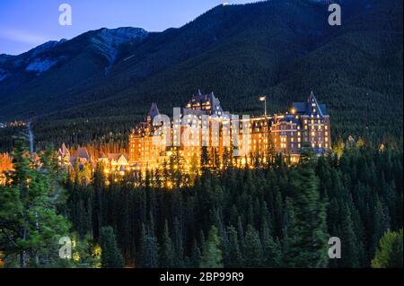 Alberta, Canada - Sep 25 2019 : Fairmont banff springs luxury hotel with illumination in the canadian rockies at Banff national park, Canada Stock Photo