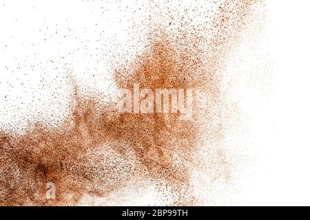 Deep brown powder dust explosion on white background. Stock Photo