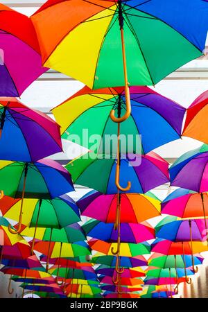 Colorful umbrellas. Protection against rain. The umbrella is open. Rainbow colors. Umbrellas on a white background. Rainbow ornament. Stock Photo