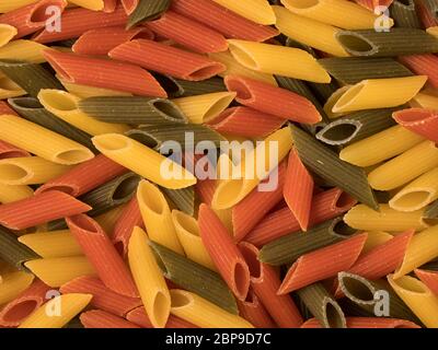 Tri-color penne pasta. Tomato, spinach and wheat pastas. Top view. Stock Photo