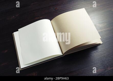 Opened blank booklet on dark wooden background. Stock Photo