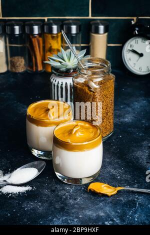 Dalgona coffee drink background. Korean coffee drink made with whipped instant coffee, sugar and milk. Stock Photo