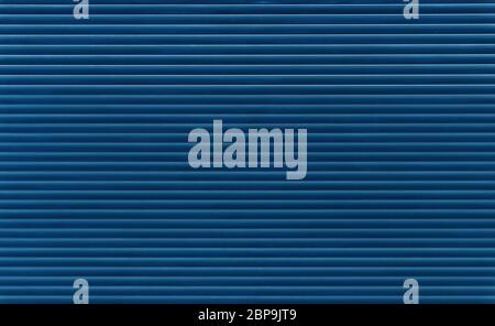 Background texture of dark blue indigo color painted horizontal metal window roller shutter blinds Stock Photo