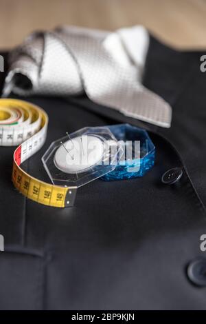 Jacket and tie detail with tailor meter and pins. Concept of Italian tailoring. Quality, style, made in Italy. Stock Photo