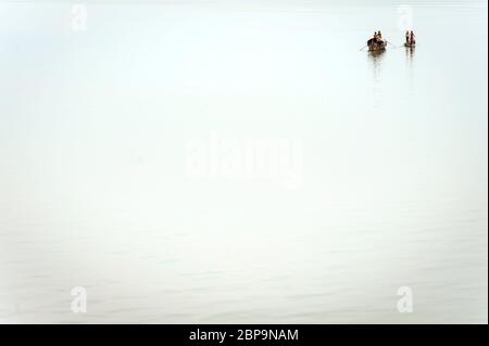 A Cambodian family on two River Boats on the Mekong River. Kampong Cham, Cambodia, Southeast Asia Stock Photo