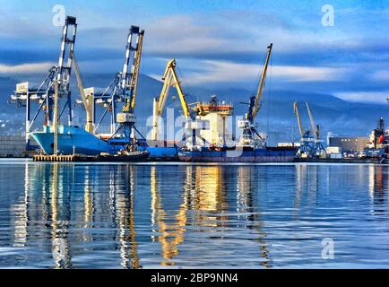 Port cranes in the port of Novorossiysk. Industrial port landscape. Stock Photo