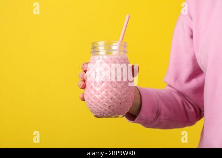 Download Woman Holds Glass Of Strawberry Milkshake On Yellow Background Stock Photo Alamy PSD Mockup Templates