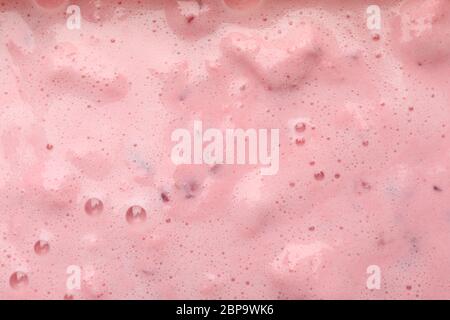 Delicious berry milkshake on whole background, close up Stock Photo