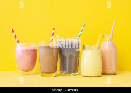 Delicious milkshakes on yellow background. Summer drink Stock Photo