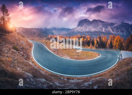 Asphalt winding road in mountains at colorful sunset in autumn Stock Photo