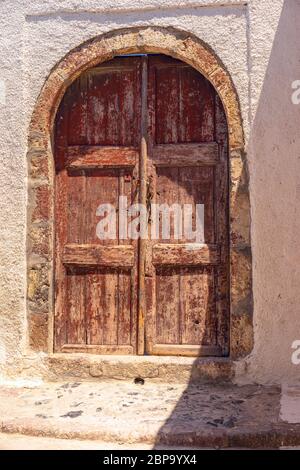 Wonderfull old textured and weathered door in Thira, Santorini Stock Photo