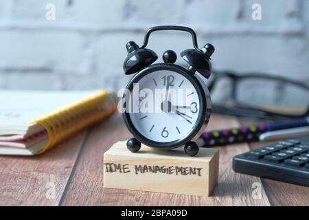 time management concept with alarm clock on table. Stock Photo