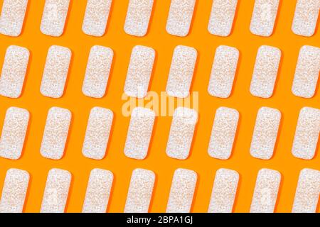 Pattern made of rice crackers or rice cakes on orange color background. Healthy organic food. Flat lay. Stock Photo