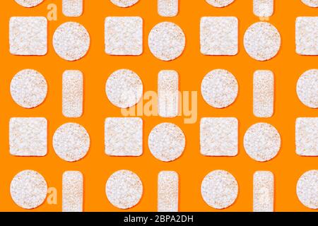 Pattern made of rice crackers or rice cakes on orange color background. Healthy organic food. Flat lay. Stock Photo