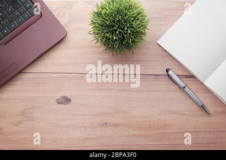 Top view of laptop, pen and notepad with copy space  Stock Photo