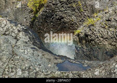 A rainbow in spray from waterfalls and rapids of Petrohue, in the Vicente Perez Rosales National Park of Los Lagos Region, near Puerto Varas, Chile Stock Photo