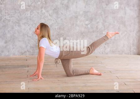 Tennage girl doing fitness gymnastics at home. Gymnastics video tutorial. Gymnastic exercises. Children's activity in quarantine during coronavirus pa Stock Photo