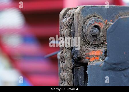 oily chain for forklift with bolt and blurry background Stock Photo