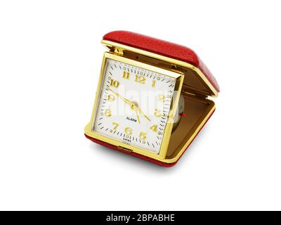 A old red folding travel alarm clock on white background Stock Photo