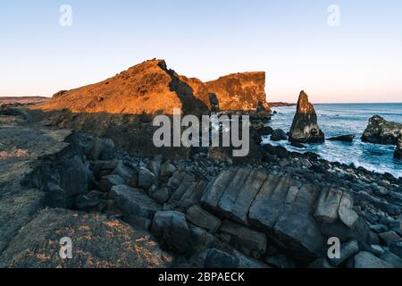 Marvelous sunset on popular tourist attraction Valahnukamol bay in southern Iceland. Cliffs are located in Reykjanes peninsula and are easily Stock Photo