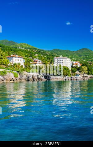 Beautiful Adriatic sea in Croatia, town of Lovran riviera, coastline villas in Kvarner bay Stock Photo