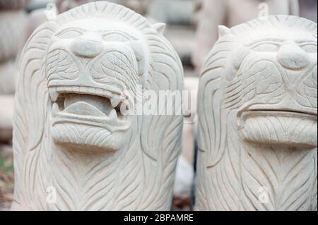 Close up of a lion carving by local artists in the Buddha carving Factory Village of Kakaoh. Battambang Province, Cambodia Stock Photo