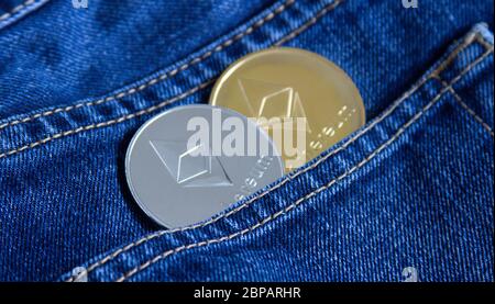 The physical version of Ethereum ETH is gold and silver in the pocket of the eden. Conceptual image for investors in cryptocurrency, blockchain techno Stock Photo