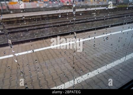 sad view through train window with raindrops Stock Photo