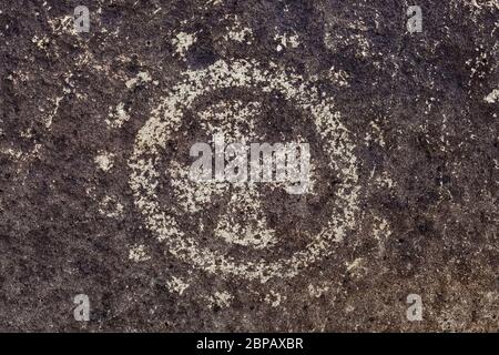 Rock art with circle and dot motif with iron cross created