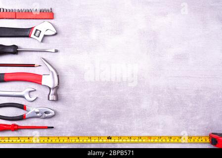 Various repair tools on a gray background. Equipment for construction. Repair tool kit. Top view template copy space Stock Photo