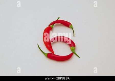 Sign 6, made from the fruit of fresh chilli red pepper with a green stalk, Sofia, Bulgaria Stock Photo