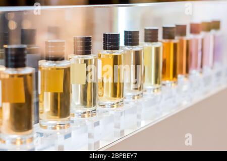 set of colorful perfume bottles in shop window. Stock Photo