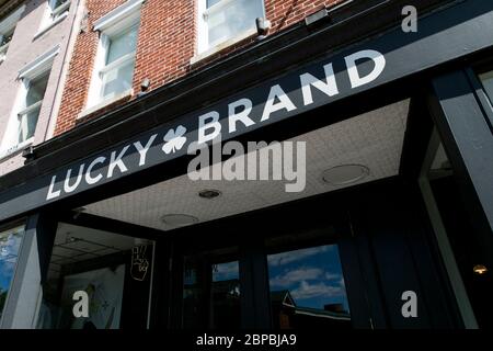 A logo sign outside of a Lucky Brand Jeans retail store location in Washington, D.C., on May 9, 2020. Stock Photo