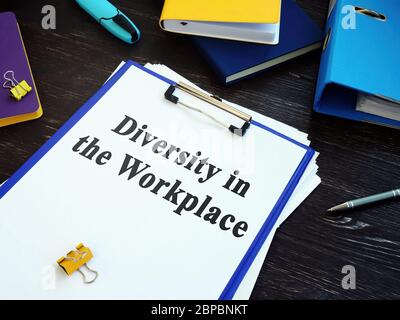Diversity in the Workplace papers with clipboard and pen. Stock Photo
