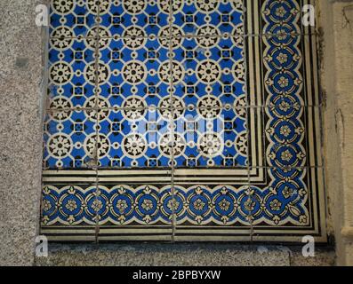 Traditional old tiles wall on the Porto streets, painted tin-glazed, azulejos ceramic tilework. Stock Photo