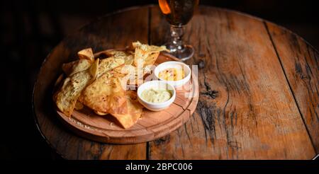 crispy fresh tortilla chips with sauces Stock Photo
