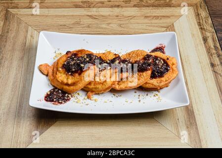 Softy fritters with chocolate cream and nuts Stock Photo