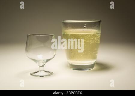 An empty glass and a glass with sparkling water, studio photography Stock Photo