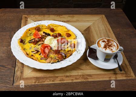 Omelet with sausages, mushrooms and onion Stock Photo