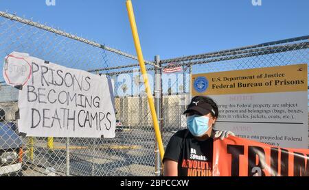 A small group of activists protest outside the Federal Correctional Institution in San Pedro, California on Saturday, May 2, 2020. The American Civil Liberties Union and other groups are suing the U.S. government over conditions at the federal prison, where close to half of the inmates have tested positive for the coronavirus. Several hundred inmates and a smaller number of staff members have tested positive for COVID-19 at Terminal Island. At least seven inmates have died from complication related to the virus. Los Angeles County health officials say all inmates in the facility are tested for Stock Photo