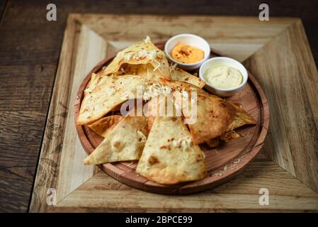 crispy fresh tortilla chips with sauces Stock Photo