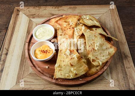 crispy fresh tortilla chips with sauces Stock Photo